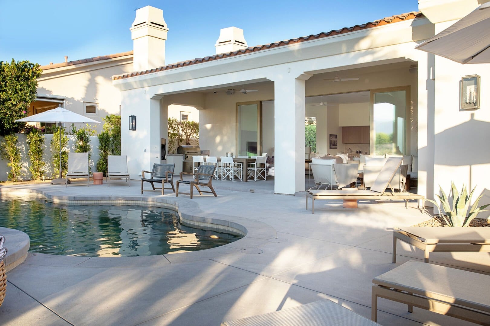 The pool and poolside furniture of our Palm Desert vacation house rentals