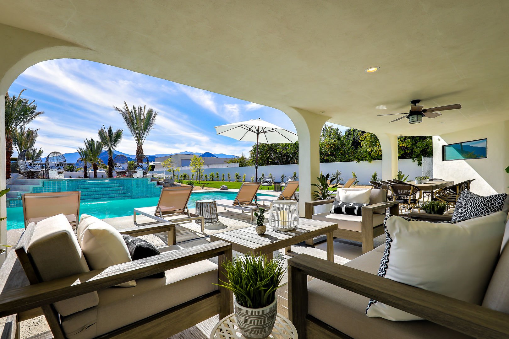 Outdoor seating set by the pool in our vacation rental in the Palm Desert area